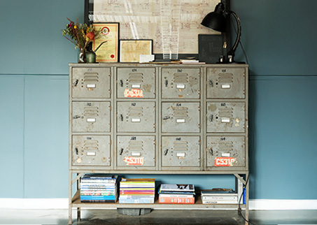 Old blue locker with books and other items rested below and on top